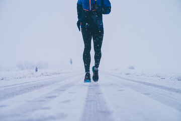 Wall Mural - man running in winter on the snow