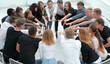 © ASDF - group of diverse young people joining their palms together