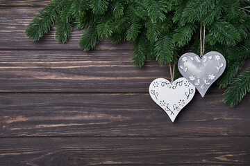 Wall Mural - Christmas or New Year background with fir branches and tin hearts