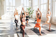 © BullRun - Diverse sportswomen doing yoga together in studio
