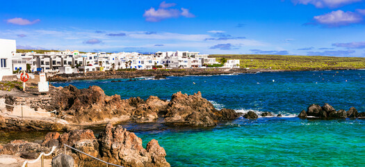 Wall Mural - Lanzarote scenic places. Charming  Punta Mujeres traditional fishing village with floral streets and white houses. popular  for natural swim pools. Canary islands travel