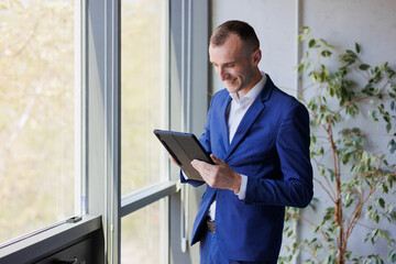 Portrait of a businessman holding a tablet