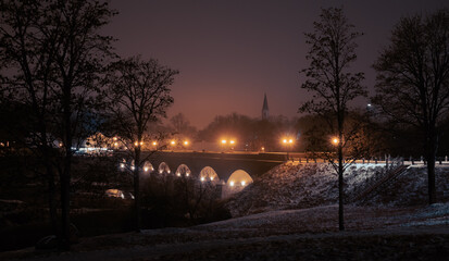 Wall Mural - Old brick bridge in lantern lights. Atmospheric view to the small town in the night. Winter