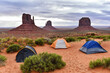 View on the famous Monument Valley from campsite with three tents in the foreground. View of West Mitten Butte, East Mitten Butte, and Merrick Butte in the morning, Arizona, USA.
