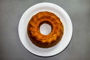 Wall Mural - Unmoulded carrot cake on a white plate.