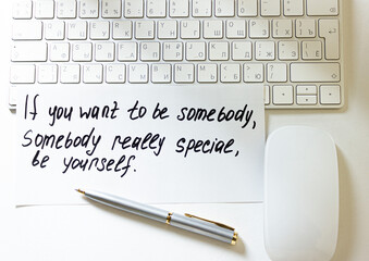 Text on keyboard background with pen