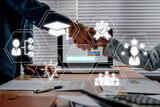 Qualification concept, business partnership handshaking after perfect deal with qualification icon on virtual screen.