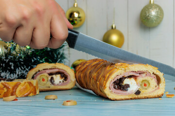 Hand with knife cutting Venezuelan christmas ham bread