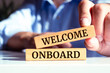 Welcome onboard symbol. Wooden blocks with words 'Welcome onboard'. Business and welcome onboard concept. 