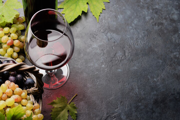 Wall Mural - Red wine in glass, bottle and grapes in basket