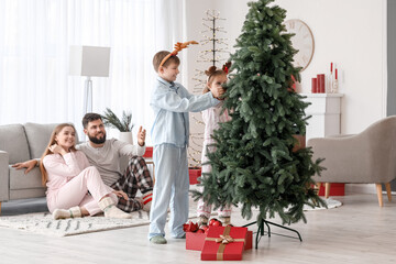 Sticker - Happy little children decorating Christmas tree at home