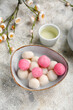 © Pixel-Shot - Bowl of tangyuan, cup and sakura on grunge background. Dongzhi Festival