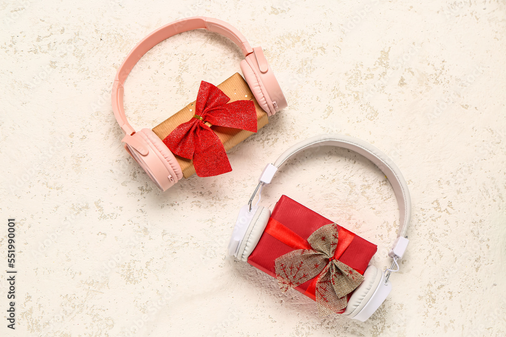 Headphones with Christmas gifts on grunge background