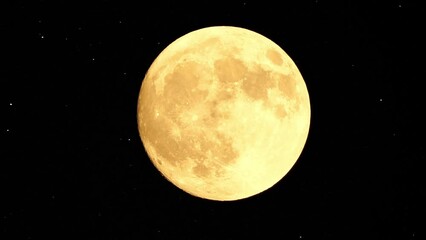Wall Mural - Full moon stars. Glowing yellow huge full moon against starry night sky as seen from earth through clouds. Large full moon moves across the sky, moon makes its way from bottom left frame to top right.