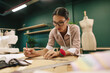 © Jacob Lund - Dressmaker making a design draft on paper