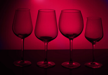 Wall Mural - Row of wine glasses on viva magenta background