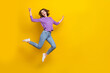 Leinwandbild Motiv Full size portrait of overjoyed nice girl jumping have good mood empty space isolated on yellow color background
