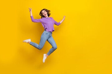 Full size portrait of overjoyed nice girl jumping have good mood empty space isolated on yellow color background
