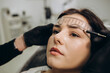 © Roman - Marking of eyebrows. Permanent brow makeup. Markings with white paste and measuring ruler