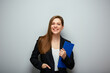 Smiling business woman holding clipboard tablet. Isolated portrait with copy space.