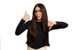 Young caucasian brunette long hair woman cutout isolated showing thumbs up and thumbs down, difficult choose concept