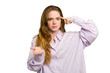 © Asier - Young caucasian redhead woman isolated holding and showing a product on hand.