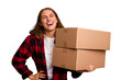 Young caucasian woman moving while picking up a box full of things isolated laughing and having fun.