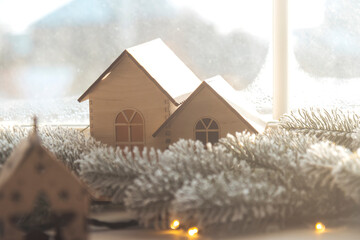 two decorative houses stand on the windowsill, New Year's decor