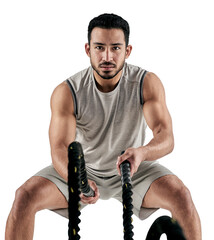 PNG studio portrait of a muscular young man exercising with battle ropes.