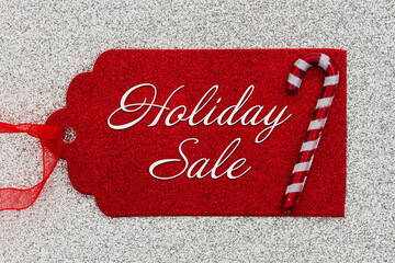 Wall Mural - Holiday Sale message on red gift tag with a candy cane