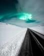 Aurora borealis, northern lights over the road, dancing queen on the clear sky during winter, Iceland