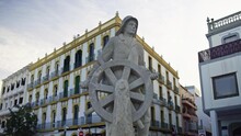 Gimbal Move To The Left With A Statue Of A Seaman In The Front In The Port Of Ibiza Town, Spain, During Sunset.