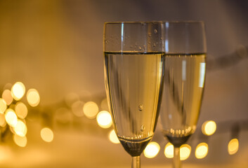 Den Helder, netherlands. december 2022. Tw glasses of champaign with a background with bokeh.