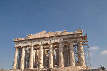 Wall Mural - The western main front of Parthenon ancient temple under a clear blue sky as a background. A visit to Acropolis of Athens, Greece.