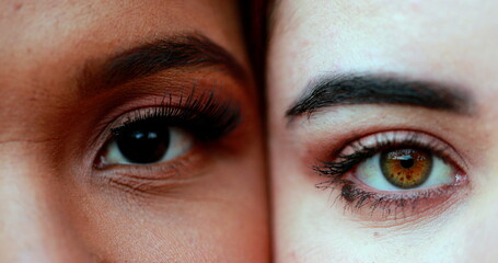 Two diverse different women close-up eyes opening