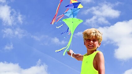 Wall Mural - Close-up portrait of a boy with colorful kites set over sky