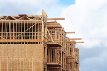 Structural Wooden Frame Of Apartment Building Under Construction