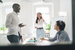 © BullRun - Group of diverse colleagues discussing project with manager in office