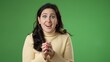 © Robert Peak - Portrait of pretty young 20s woman getting great success winner isolated over green screen background in studio. People sincere emotions, lifestyle concept. Looking at the camera
