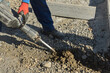 © ungvar - Concrete surface of road was dug and drilled by construction road workers using jackhammer