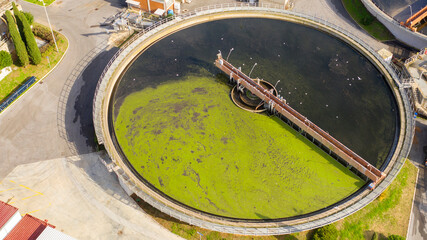 Wall Mural - Aerial view of the tanks of a sewage and water treatment plant enabling the discharge and re-use of waste water. It's a sustainable water recycling with treatment plant.