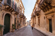 © ADDICTIVE STOCK - Female tourist walking between ancient buildings
