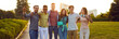 © Studio Romantic - Happy young people enjoying summer, spending time outdoors and having fun together. Joyful excited diverse friends standing in the city park, hugging each other and smiling. Group portrait. Banner