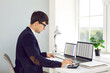 © Studio Romantic - Serious young man office worker is working with spreadsheets on computers screens and making calculations. Business analytics, accounting, finance, data analytics, data science, marketing concept.