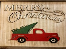 Vintage Wood Engraved Winter Holiday Merry Christmas Greeting Text & Happy New Year Old Red Festive Pick Up Truck With Farm Fresh Cut Fir Tree Gift In The Luggage Bed Sign Wall Decor Delivery Concept.
