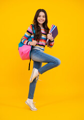 Canvas Print - Happy school teenage girl with book and copybook. Teenager schoolgirl student, isolated background. Learning and knowledge. Go study. Education concept.