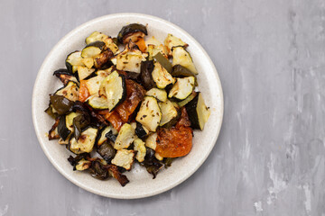 Wall Mural - Mixed baked vegetables on light brown dish