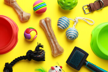 Poster - Flat lay composition with pet toys and feeding bowls on yellow background