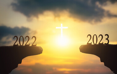 Wall Mural - new hope concept: 2023 on sunset sky background with white cross