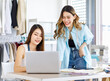 © Bangkok Click Studio - Millennial Asian young beautiful professional female designer dressmaker businesswoman advising helping talking with colleague working together with laptop notebook computer in tailor workshop studio